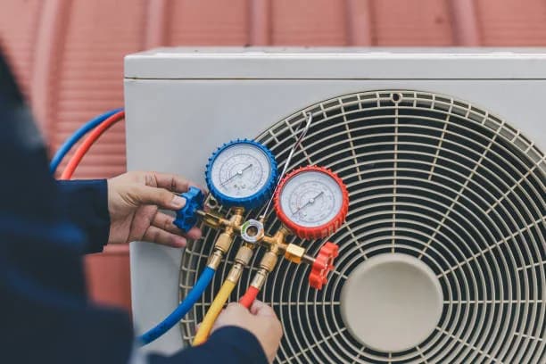 Manifold gauges connected to a mini-split outdoor unit